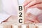 Three wooden cubes with letters B2C - means business to consumer