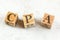 Three wooden cubes with letters CPA stands for Cost per Action Acquisition on white board.