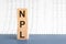 Three wooden cubes with letters NPL - short for Non Performing Loans, concept