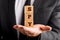 Three wooden cubes stacked on the palm of officers hand reading