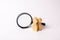 Three wooden human figure stands near a magnifying glass on a white background. The concept of the search for people and workers.