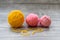 Three wool balls on the wooden background.