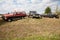 Three work trucks in a field