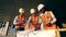 Three workers look at a blueprint on a construction site. Construction workers at modern construction site.