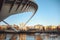 Three yachts sailing under the Gateshead Millennium Bridge on River Tyne