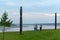 Three Yakut girl friends, one wrapped in a blanket, walk away from the river past the ritual national pillars of Serge