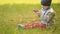 Three-year baby playing with phone on grass