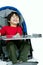 Three year old biracial disabled boy in medical stroller, happy