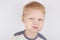 Three-year-old boy with a mouth smeared with cake crumbs on a white background