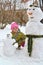 The three-year-old girl sitting plays with snowmen