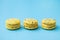 Three yellow cakes on a blue background