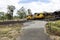 Three yellow coal train engines at a depot.