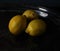 Three Yellow Lemons on a Tarnished Silver Tray