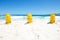 Three yellow life saving buoys on beach