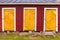 Three yellow locked doors in red rural barn