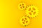 Three yellow mechanical gear cogwheels over yellow background - industry, teamwork, solution or cooperation minimal modern concept