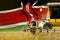 three yellow modern combine harvesters with Kenya flag on rye field - close view, farming concept - industrial 3D illustration