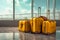 Three yellow suitcases on the floor in airport terminal. Travel concept.