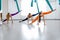 Three yogi women makes side splits using blue hammock for aerial fly yoga. Concept wellness yoga, group training.