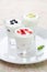 Three yogurt with fruit in a glass beaker vertical