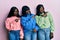 Three young african american friends wearing wool winter sweater pointing aside worried and nervous with forefinger, concerned and