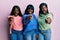 Three young african american friends wearing wool winter sweater pointing displeased and frustrated to the camera, angry and