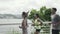 three young asian people running outdoors in park by the sea