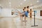 Three young ballerinas rehearsing at the barre