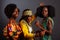 Three young beautiful African fashion models have fun and laughing in traditional dress. Women from the Congo Republic