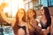 Three young beautiful girls in bikini make selfie in swimming pool at summertime.