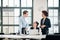 Three young colleagues talking during break in the meeting room