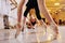 Three young cute ballerinas perform exercises on a choreographic machine or barre