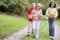 Three young friends walking on path with pumpkins