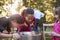 Three young girls apple bobbing at a backyard party