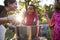 Three young girls have fun apple bobbing at a backyard party