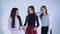 Three young girls have a fun at camera on white background