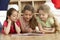 Three Young Girls Reading Book at Home