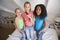 Three Young Girls Standing On A Bed