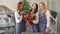 Three young handsome chef florists pose smiling in camera with ready fruit bouquet