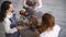 Three young handsome chef florists work at flowers fruit shop making fruit and vegetable bouquet