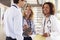 Three young male and female doctors in consultation