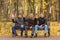 Three young men in black outerwear sitting on