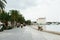 Three young men sit on the Adriatic sea promenade, relax and talk.