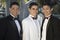Three Young Men In Tuxedos Standing Together at Quinceanera