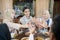 three young people celebrate and raise glasses of fruit ice for toast during iftar together