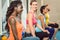 Three young people holding kettlebells during functional trainin