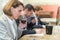 Three young people taking notes while doing wine tasting