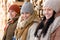 Three young people winter fashion wooden logs