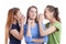 Three Young Positive Caucasian Girlfriends Sharing Their Secrets Whispering to Ears.Isolated Over White Background