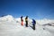 Three young skiers in mirrored masks on top on a Sunny day